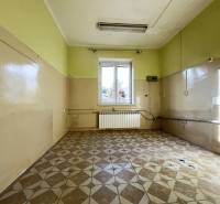 A room in a 5 or more bedroom apartment with a tiled floor and a window.