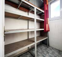 Storage space with shelves and tiled floor in a 5 or more room apartment.