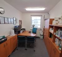 Offices with furniture, certificates on the wall, and shelves with products.