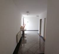 A corridor of offices with tiles and decoration.