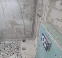 Installation of underfloor heating in the bathroom of a family house.