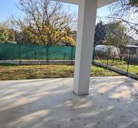 A family house in Piešťany with a garden, a fenced yard with a lawn and trees on the property.