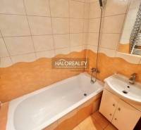 A bathroom in a 4-room apartment with a shower bath and a sink.