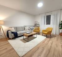 A living room in a two-room apartment with a wooden decor floor and comfortable furnishings.