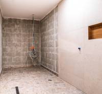 A bathroom in a family house with a stone floor during renovation.