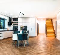 Interior of a family house with a kitchen, staircase, and floor with a wood decor.