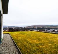 A family house in Stará Ľubovňa with a view of the city and a well-maintained grassy garden.