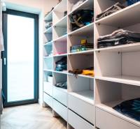 Wardrobe wall and floor with wood decor in the closet of a family house.