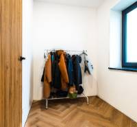 Interior of a family house with a coat rack, floor with wooden decor.