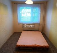 A simple bedroom with a bed and a window in a 3-room apartment.