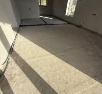 Interior of a family house with a concrete floor and large windows from Most pri Bratislave.