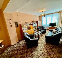Living room in a two-room apartment with a sofa set and a glass display cabinet.