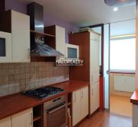 A studio apartment kitchen with a gas stove and glass cabinets.