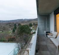 A balcony in a one-room apartment, view of nature, overlooking gardens and trees.