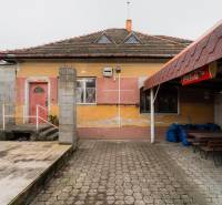 A family house on Partizánska Street in Bánovce nad Bebravou with a colorful facade and outdoor seating.