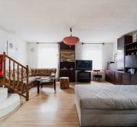 Living room in a family house with a wooden decor floor and comfortable seating.