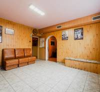 The interior of the house with armchairs, tiles, and paneled walls, tiled floor.