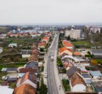 A family house on Partizánska Street in Bánovce nad Bebravou, lined with other houses.