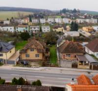 Family houses on Partizánska Street in Bánovce nad Bebravou with the surrounding landscape.