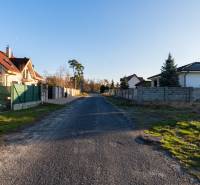 Borovicová Street in Lozorno with houses and residential plots, grassy areas.
