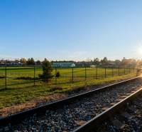 A railway track at sunset in Lozorno on Borovicová, surrounded by green residential lands.
