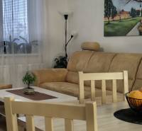 A comfortable sofa in a 3-room apartment with a wooden decor floor and decorative elements.