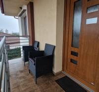 Balcony of a 3-room apartment with seating, view of Vozokany and surrounding rooftops.
