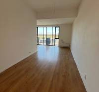 A bright room with a wood-decor floor in a 2-room apartment.
