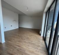 Spacious living room in a 2-room apartment with a balcony, floor with wood decor.
