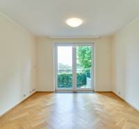 A room with a wooden floor decor and a large window in a 3-room apartment.
