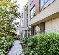 An apartment building on Mudroňova Street in Bratislava - Old Town, surrounded by greenery and a garden.