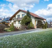 A villa in Žarnovica on Andrej Sládkovič Street surrounded by greenery and mountains.