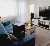 Living room in a 3-room apartment with a sofa, television, and coffee table.