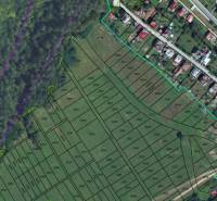 Plan of Development Plots in Snežnica with Displayed Parcels and Surrounding Forest.