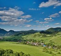 Beautiful landscape around Lechnice with agricultural and forest lands under the blue sky.