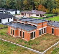 A family house on Medová Street in Lednické Rovne, surrounded by green gardens and a forest.
