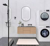 A bathroom in a family house with a washing machine, dryer, and shower.