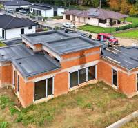 A family house under construction on Medová Street in Lednické Rovne, surrounded by a green lawn.
