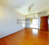 A room in a 3-room apartment with a wood-patterned floor and a built-in wardrobe.