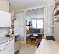 2-bedroom apartment with a kitchen and living area, wooden decor flooring.
