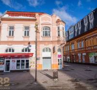 A historic building in Poprad surrounded by shops on the square.