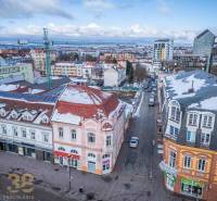 A view of snow-covered buildings in Poprad with the panorama of the Tatras in the background.