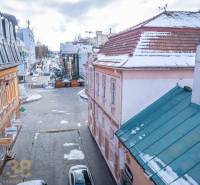 Winter street in Poprad, buildings with historical architecture, snow on the roofs and pavement.