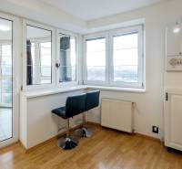 A bright room with a gas boiler, bar stool, wooden decor flooring in a 3-room apartment.