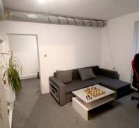 Living room with a sofa, chessboard, and carpet in a family house.