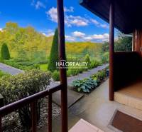 Gardens in Bytča with maintained paths, a hedge, and a view of greenery.