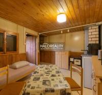 Interior with a table, chairs, and an armchair with fabric upholstery, floor with wood decor.