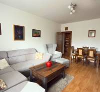 Living room in a 3-room apartment with a corner sofa and a wooden decor floor.