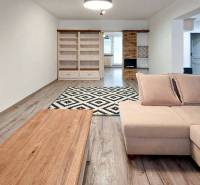 Living room in a 3-room apartment with a sofa and a wooden decor floor.