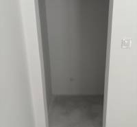 Narrow storage spaces with a concrete floor in a family house.